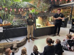 Zookeeper and a person of Snake Patrol Surinam with Ball Pythons at the lower floor of the Reptielenhuis De Aarde zoo, during the Halloween 2020 event