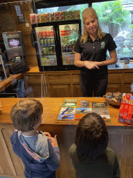 Max and his friend handing over their Halloween Quest paper to the zookeeper at the lower floor of the Reptielenhuis De Aarde zoo, during the Halloween 2020 event