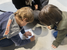 Max and his friend doing the scavenger hunt at the lower floor of the Reptielenhuis De Aarde zoo, during the Halloween 2020 event