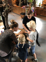 Visitors with a Stick Insect at the lower floor of the Reptielenhuis De Aarde zoo