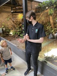 Zookeeper with an Australian Walking Stick at the lower floor of the Reptielenhuis De Aarde zoo