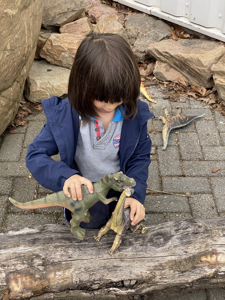 Max playing with dinosaur toys at the garden of the Reptielenhuis De Aarde zoo