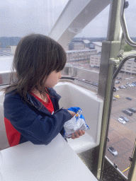 Max with chips in our capsule at the Smakenrad ferris wheel at the Chasséveld square