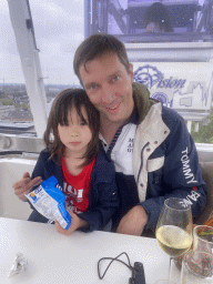 Tim and Max with chips and wine in our capsule at the Smakenrad ferris wheel at the Chasséveld square