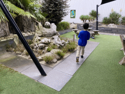 Max with a Crocodile statue in the garden of the Reptielenhuis De Aarde zoo