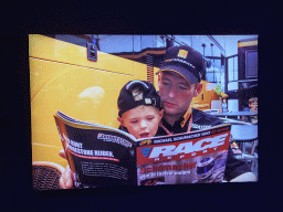 Photograph of Jos Verstappen and Max Verstappen reading a magazine in 2000, at the `Vleugels to the Max` exhibition at the Koepelgevangenis building