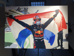 Photograph of Max Verstappen with a Dutch flag at the `Vleugels to the Max` exhibition at the Koepelgevangenis building