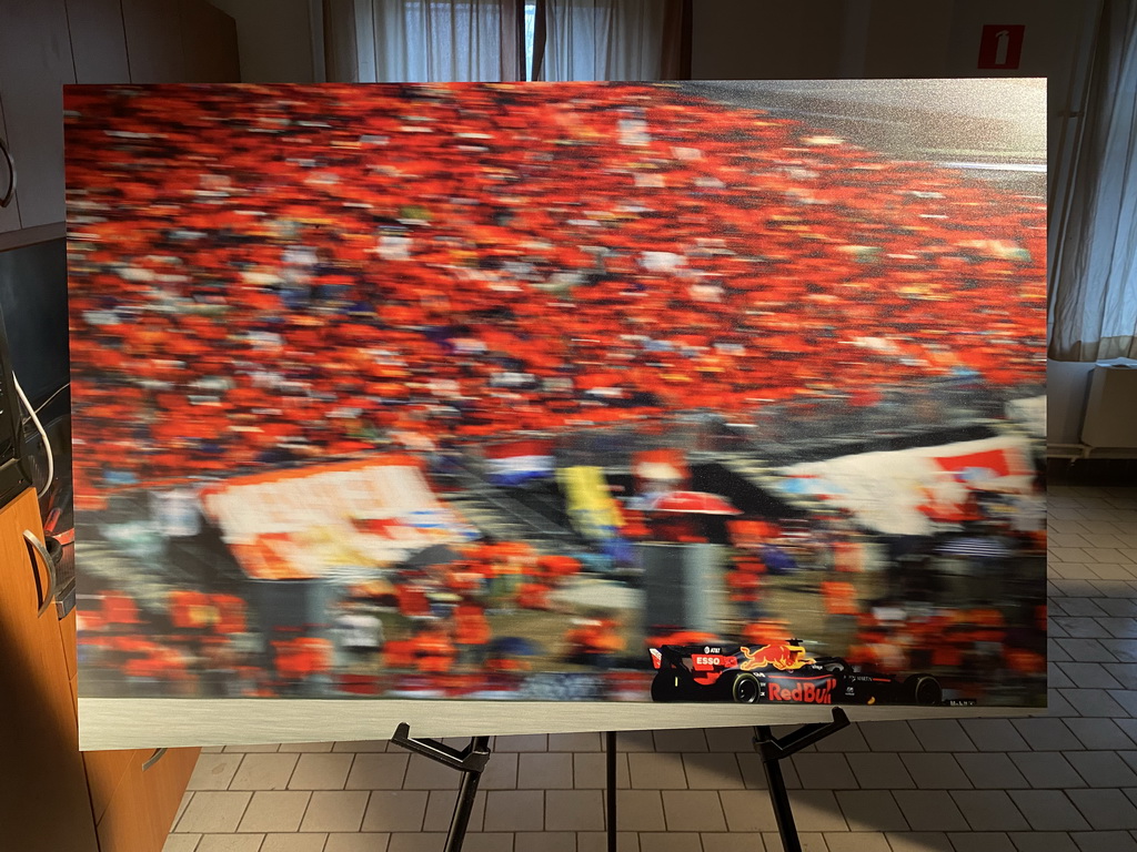 Photograph of Max Verstappen in a Formula 1 car and the `Orange Army` in 2019, at the `Vleugels to the Max` exhibition at the Koepelgevangenis building