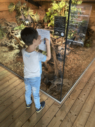 Max writing for the scavenger hunt at the upper floor of the Reptielenhuis De Aarde zoo
