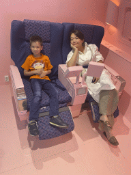 Miaomiao and Max in airplane seats at the SuperNova Experience museum