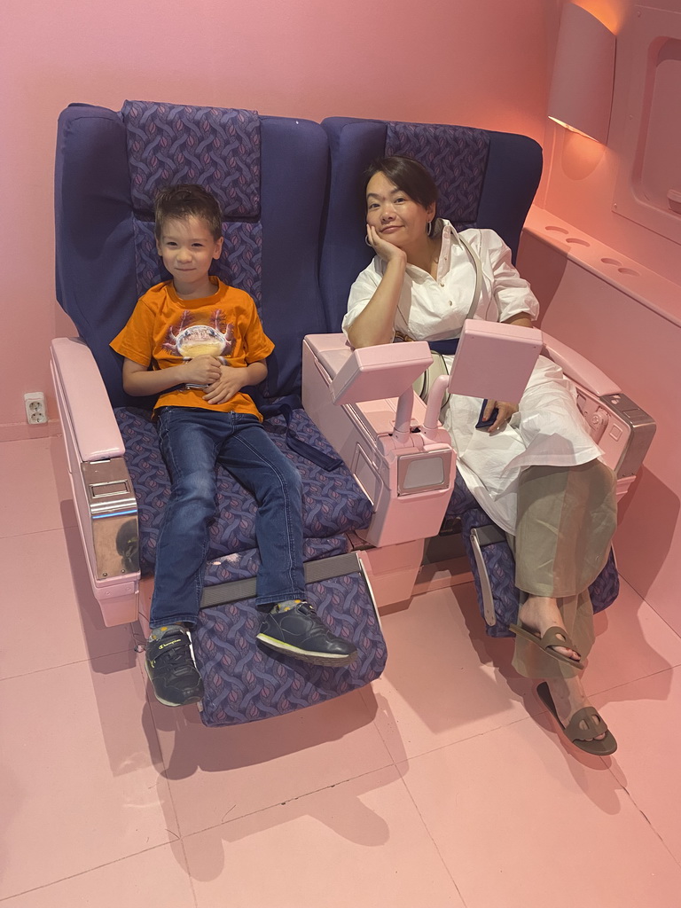 Miaomiao and Max in airplane seats at the SuperNova Experience museum