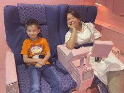 Miaomiao and Max in airplane seats at the SuperNova Experience museum