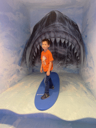Max surfing in front of a shark at the SuperNova Experience museum
