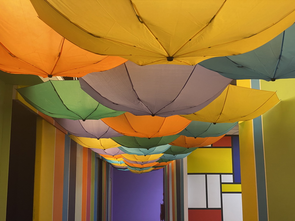 Umbrellas hanging from the ceiling of a hallway at the SuperNova Experience museum