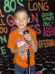 Max with a microphone at the music studio room at the SuperNova Experience museum