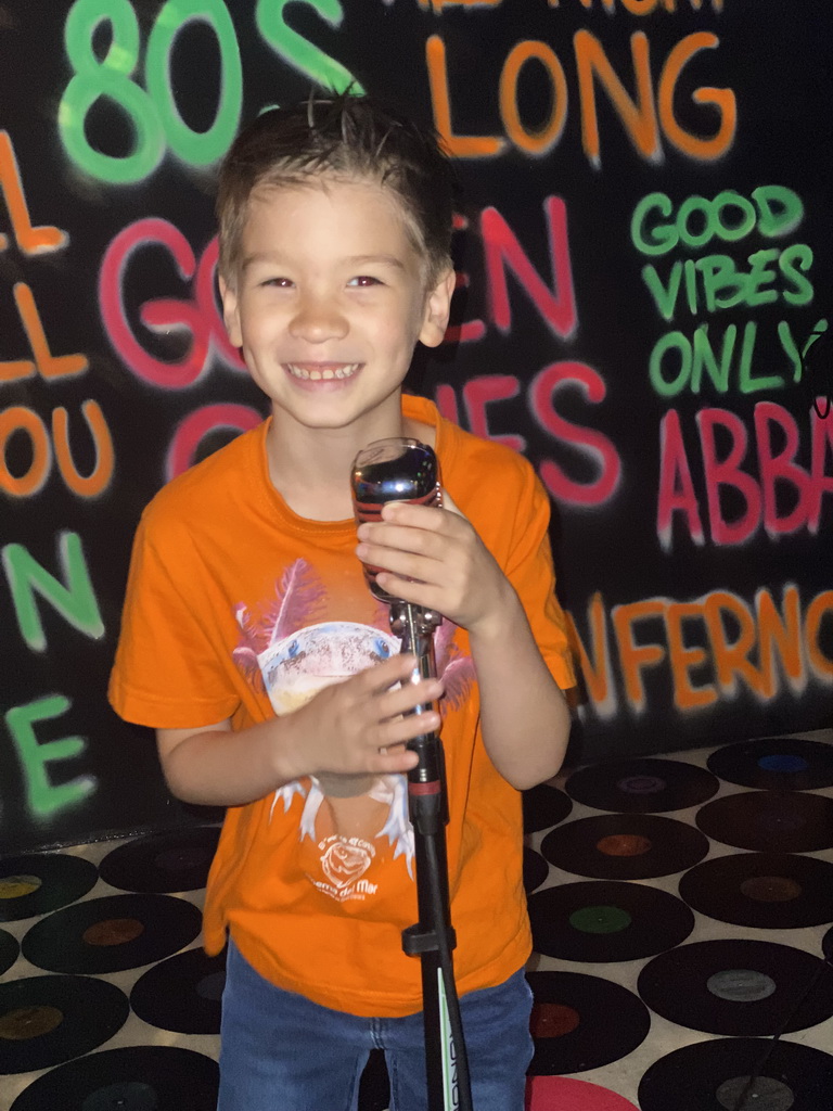 Max with a microphone at the music studio room at the SuperNova Experience museum