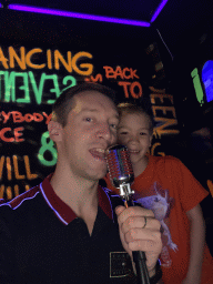 Tim and Max with a microphone at the music studio room at the SuperNova Experience museum