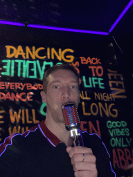 Tim with a microphone at the music studio room at the SuperNova Experience museum