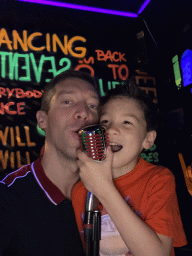 Tim and Max with a microphone at the music studio room at the SuperNova Experience museum