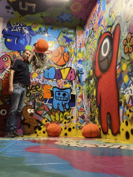 Tim with a basketball at the graffiti room at the SuperNova Experience museum