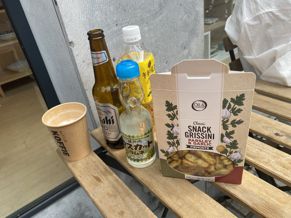 Snacks and drink at the terrace of the K.O.I. Kanpai store at the Halstraat street