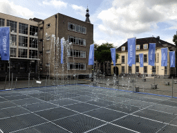 The Peace Fountain at the Kasteelplein square, with a view on the tower of the Grote Kerk church