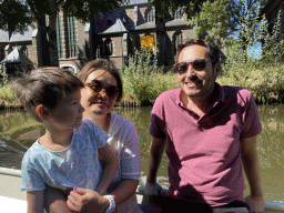 Miaomiao, Max and our friend on our tour boat on the Aa of Weerijs river, with a view on the former Annakerk church