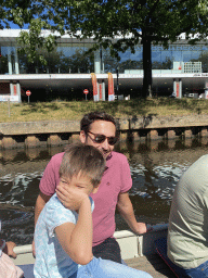 Max and our friend on our tour boat on the Aa of Weerijs river, with a view on a building at the Tramsingel street