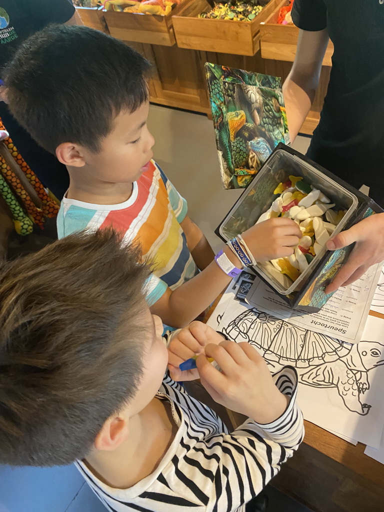 Max and his friend getting candy for the scavenger hunt at the lower floor of the Reptielenhuis De Aarde zoo