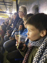 Max and his friend having drinks at the F9 grandstand of the Rat Verlegh Stadium, during the match NAC Breda - FC Den Bosch