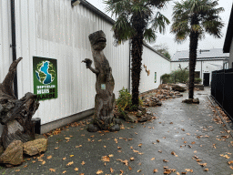 Entrance sign and statue of a Tyrannosaurus Rex at the entrance to the Reptielenhuis De Aarde zoo at the Aardenhoek street