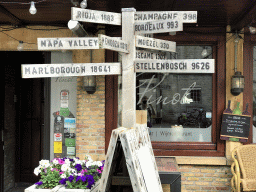 Signpost in front of the Wijnbar Pinot restaurant at the Grote Markt square