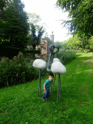 Max with Flamingo statues at the northeast side of the gardens of Bouvigne Castle
