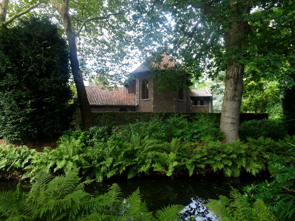 Canal and back side of the Chapel at the English Garden of Bouvigne Castle, viewed from the German Garden