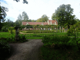 Statue at the English Garden of Bouvigne Castle, with a view on the French Garden and the Koetshuis and Poortgebouw buildings