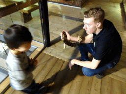 Max and a zookeeper with a Ball Python at the upper floor of the Reptielenhuis De Aarde zoo