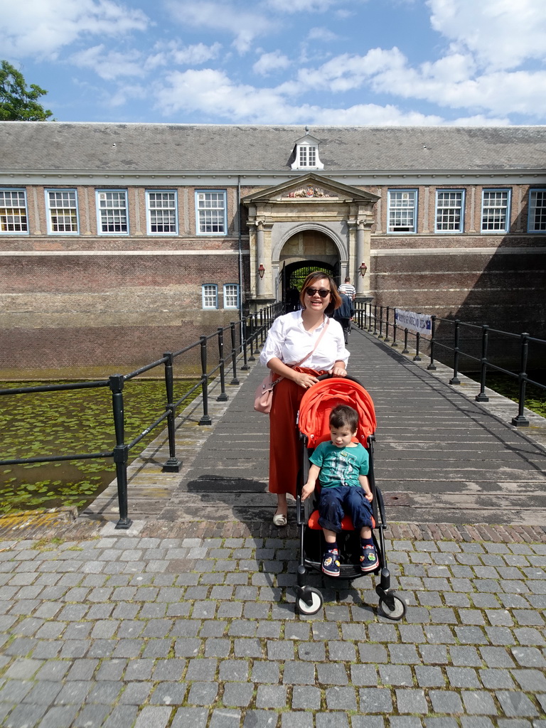 Miaomiao and Max in front of the southern bridge and the Stadtholder`s Gate to Breda Castle at the Kasteelplein square