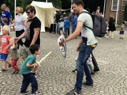 Tim and Max with a wooden sword and shield at the Parade square of Breda Castle, during the Nassaudag