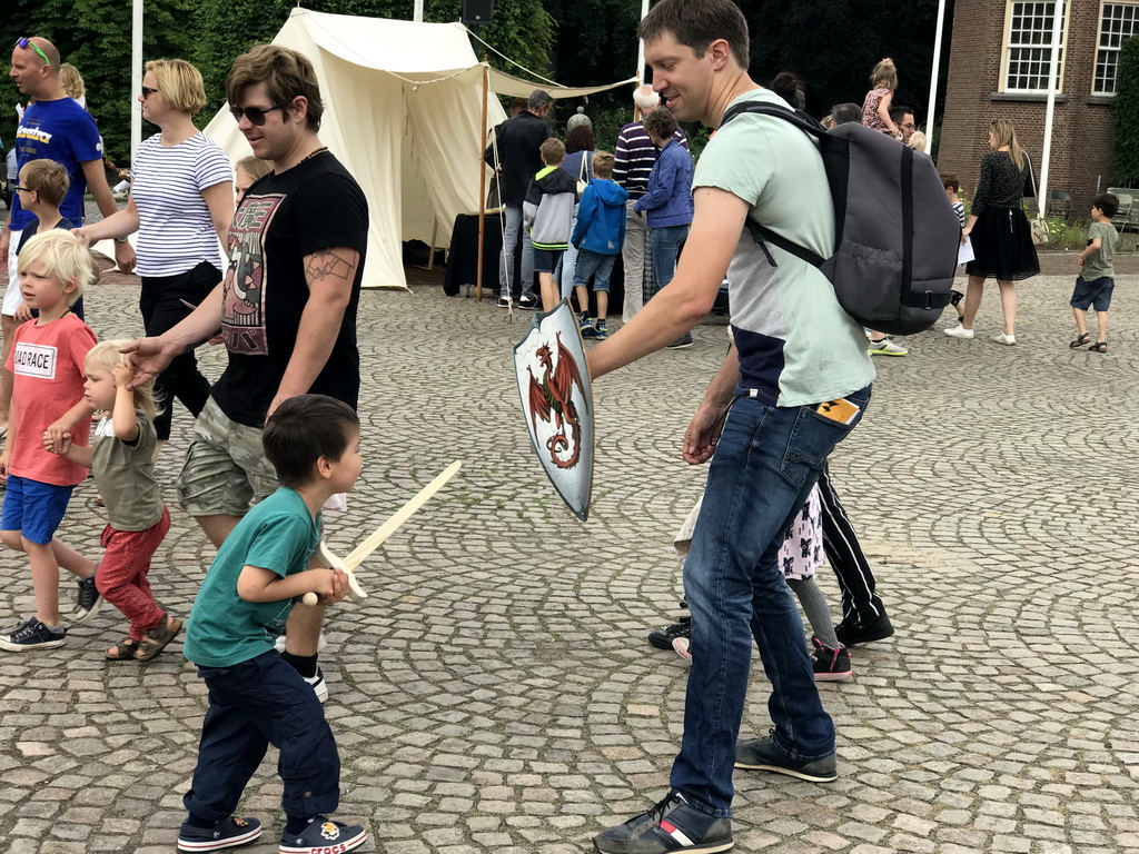 Tim and Max with a wooden sword and shield at the Parade square of Breda Castle, during the Nassaudag