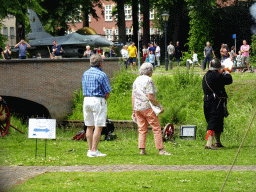 Actor firing a musket and a jet fighter at the southwest side of Breda Castle, viewed from the Cingelstraat street, during the Nassaudag