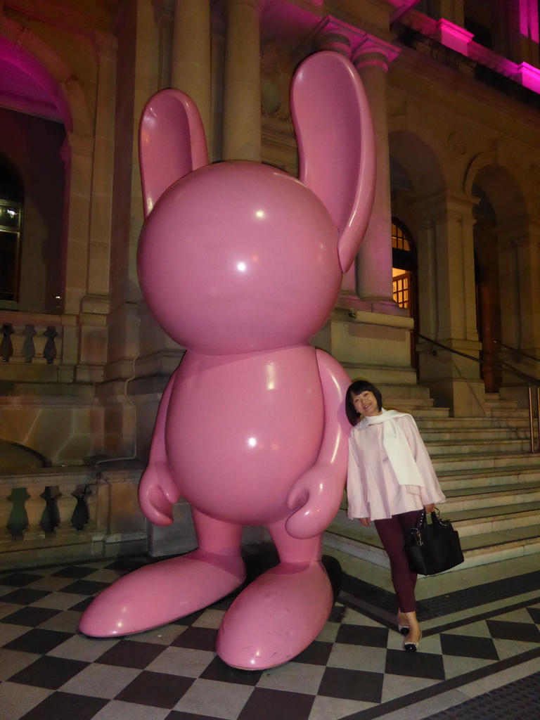 Miaomiao with a rabbit statue in front of the Treasury Casino at Queen Street, by night