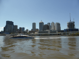 Boat in the Brisbane River and the skyline of Brisbane, viewed from the Clem Jones Promenade