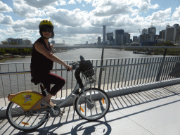 Miaomiao on her CityCycle bicycle at the Goodwill Bridge, with a view on skyline of Brisbane with the Infinity Tower, the Victoria Bridge over the Brisbane River, the Wheel of Brisbane and the South Bank Parklands