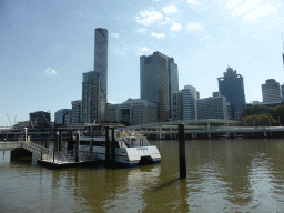 The Miramar Koala & River Cruise boat on the Brisbane River and the skyline of Brisbane with the Infinity Tower, viewed from the Southbank Boardwalk