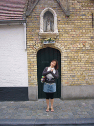 Miaomiao with a statuette of St. Mary in a small chapel at the Oostmeers street