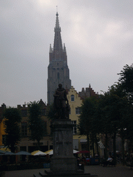 Statue of Simon Stevin at the Simon Stevinplein square, and the tower of the Church of Our Lady