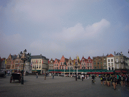 The Markt square with horse and carriage, restaurants and the Statue of Jan Breydel and Pieter de Coninck