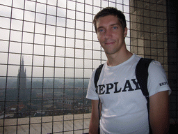 Tim at the top floor of the Belfort tower, with a view on the Church of Our Lady