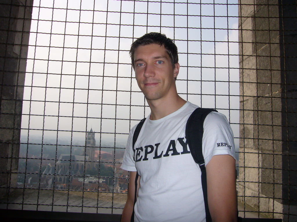 Tim at the top floor of the Belfort tower, with a view on the St. Salvator`s Cathedral