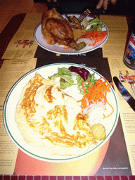 Spanish omelette and chicken for lunch in a restaurant in the city center